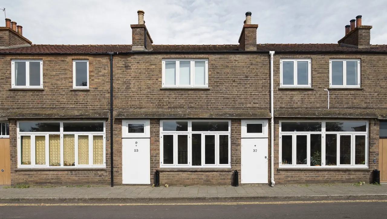 A bay-fronted house with new double-glazed windows across the front elevation